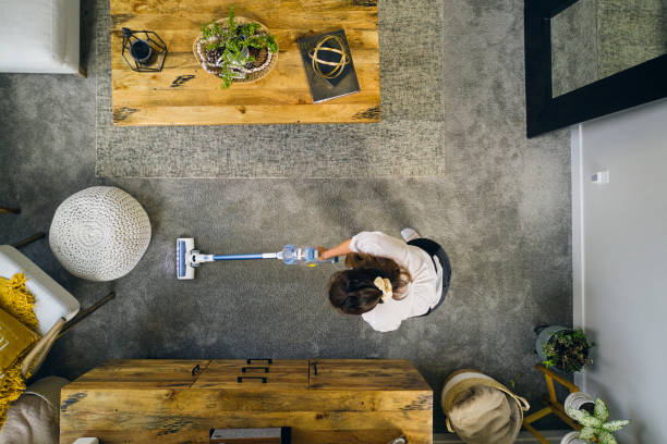 A professional housecleaner at work cleaning a home.