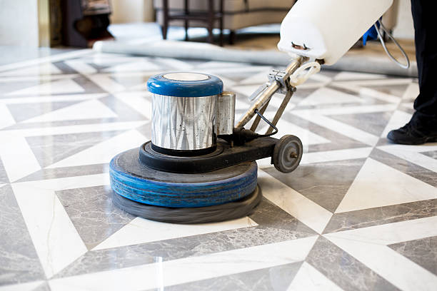 man polishing marble floor in modern office building